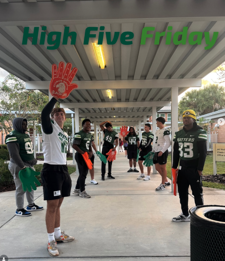 Stetson football players participating in a faith and character community moment.